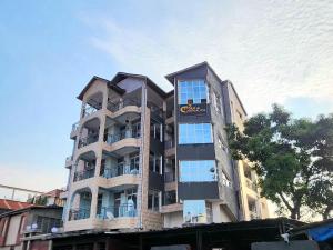 a building with a sign on the side of it at Etoile de Nathalice in Kinshasa