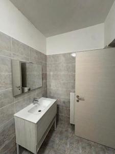 a bathroom with a white sink and a mirror at Eden Affittacamere in Anzio +31 photos