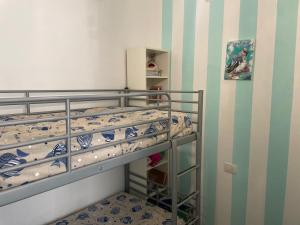 a small bedroom with a bunk bed and a staircase at Smartop Apartment in Forte dei Marmi +1 photo