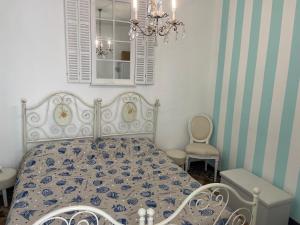 a bedroom with a bed and a chandelier at Smartop Apartment in Forte dei Marmi