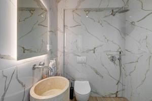 a bathroom with a sink and a toilet at Syranna in Ermoupoli