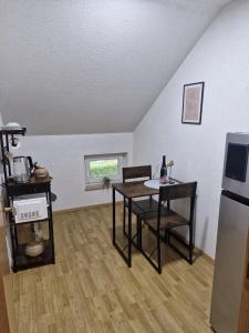 a living room with a table and a refrigerator at Duvnjak Rooms & House in Livno