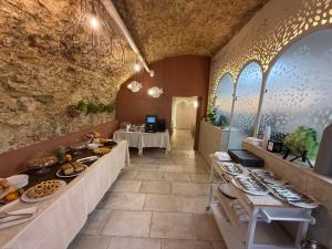 a restaurant with a buffet line with plates of food at Palazzo Naso in Tropea