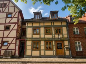 ein altes Gebäude mit orangefarbenen Türen an einer Straße in der Unterkunft Hotel Katharinenhöfchen in Salzwedel
