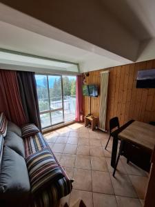 a living room with a couch and a table at Casa Cris SoleAlto in Marilleva