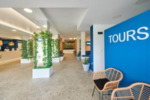 a view of a lobby with chairs and plants at Casablanca Hotel - All Inclusive in Obzor +37 photos