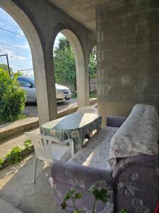 a patio with a table and a table and chairs at Nin Apartman Free Parking in Kaluđerica +1 photo