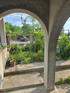 an archway with potted plants in a garden at Nin Apartman Free Parking in Kaluđerica