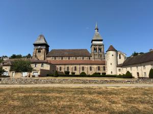an old castle with two towers and a grass field at Maisonnette in Chambon-sur-Voueize