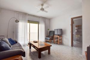 a living room with a couch and a table at Casa Bon Matí in L'Ampolla
