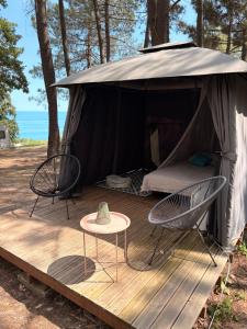 a tent with two chairs and a table on a deck at Ecoclub in Varna City