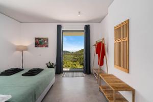 a bedroom with a bed and a large window at Mediterra Messinia in Kalamata +46 photos