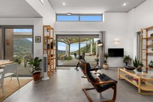 a living room filled with furniture and a large window at Mediterra Messinia in Kalamata