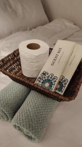 a basket with a roll of toilet paper and a book at Mactan Cozy Hub Amani Grand in Lapu Lapu City +11 photos