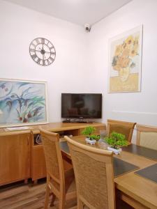 a dining room with a table and a tv at Babel Hostel, Dworzec PKP, Rynek in Wrocław
