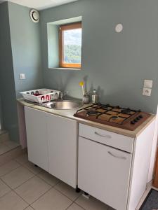 a kitchen with a sink and a counter top at Maisonnette in Chambon-sur-Voueize +8 photos