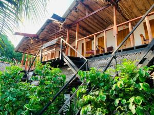 a building with a staircase in front of some plants at Arugam Bay Beach House in Pottuvil
