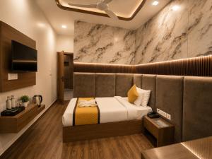 a hotel room with a bed and a television at The Vacation Villa Agra A Boutique Hotel Near Taj Mahal in Agra