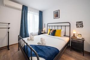 a bedroom with a large bed with blue curtains at Central Summer Theatre Suites in Veliko Tŭrnovo