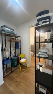 a room with shelves and a yellow chair in it at Centro Storico Caruggi 2min Acquario Pellicceria Superior Loft Palazzo Rolli in Genoa