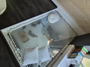 a wire cage with white papers in it at Sauna-ForRest in Marynin