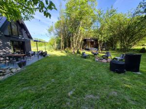 a yard with chairs and tables next to a building at Sauna-ForRest in Marynin