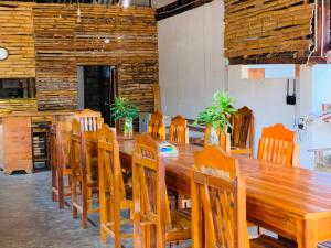 a large wooden table and chairs in a room at Arugam Bay Beach House in Pottuvil +48 photos