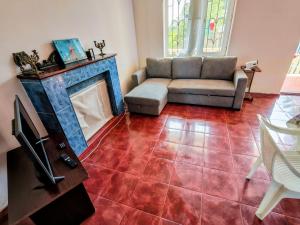a living room with a couch and a fireplace at Large house at the beach. in Grigoleti