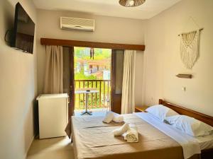 a bedroom with a bed with towels on it at Aetherion in Agios Ioannis Pelio +102 photos