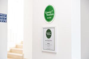 a sign for a green forest shop on a wall at Boutique Hotel and Spa Blanc & Bleu - Blanche in Herceg-Novi
