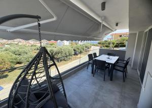 a patio with a table and chairs on a balcony at Eternity fresh in Limenaria