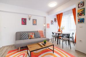 a living room with a couch and a table at Central Summer Theatre Suites in Veliko Tŭrnovo