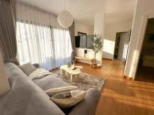 a living room with a couch and a table at Link Mansion in Chiang Mai