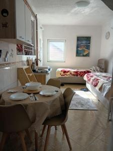a kitchen and living room with a table and chairs at Visitor view apartment in Plav