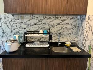 a kitchen with a sink and a counter top at Tiara Homestay Desaru - Nature view in Bandar Penawar +30 photos