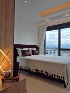 a bedroom with a bed and a large window at Luxury apartment with panoramic sea view ruby in Alanya