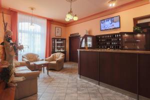 a large room with a bar and a living room at Hotel Victoria in Pilsen