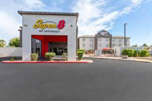 a store with a sign on the side of a street at Super 8 by Wyndham Mesa Gilbert in Mesa