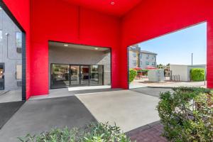 a red facade of a building with windows at Super 8 by Wyndham Mesa Gilbert in Mesa