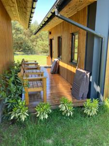 a porch of a house with a wooden deck at Leśny zakątek in Wisełka +56 photos