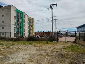 an empty parking lot in front of a building at Hotel Iraca in Aquitania