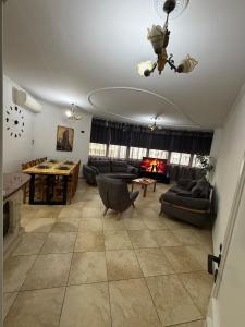 a large living room with couches and a table at Tirana Skyline Apartment in Tirana
