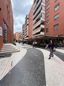 a woman walking down a street in a city at Tirana Skyline Apartment in Tirana