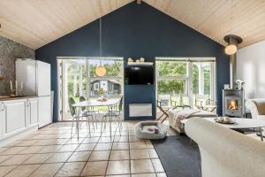 a kitchen and living room with a blue wall at 8843-Glesborg-Lyngtoften-34 in Glesborg +18 photos