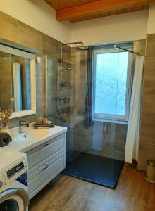 a bathroom with a shower and a sink at Vulcanus Apartment in Badacsonytomaj