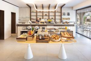a large kitchen with a table with food on it at Hôtel Spa & Restaurant - Son de Mar in Porto-Vecchio