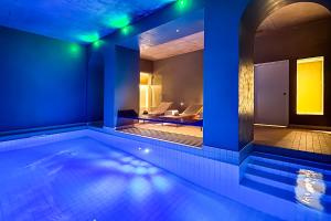 a swimming pool in a house with blue lights at Hôtel Spa & Restaurant - Son de Mar in Porto-Vecchio +54 photos
