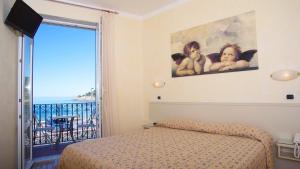 a bedroom with a bed and a view of the ocean at Hotel Feluca in Bonassola +54 photos