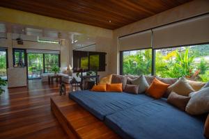 a living room with a large couch in the middle at Arcana Wellness Center - Adults Only in Ko Phangan