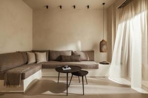 a living room with a couch and a table at Levante Afitos Suites - Adults Only in Afitos